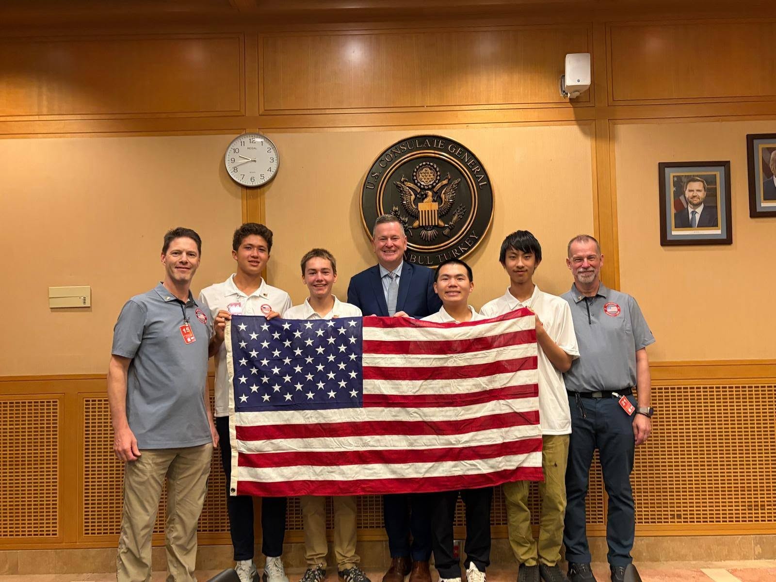 Team USA 2026 from L to R in Istanbul, Türkiye: Coach Steve Muench, Roman Gagliardi (CT), Connor Windust (VA), Consul General Michael Lally, De-An Chen (MN), William Liao (MD), Coach Jason Flowers